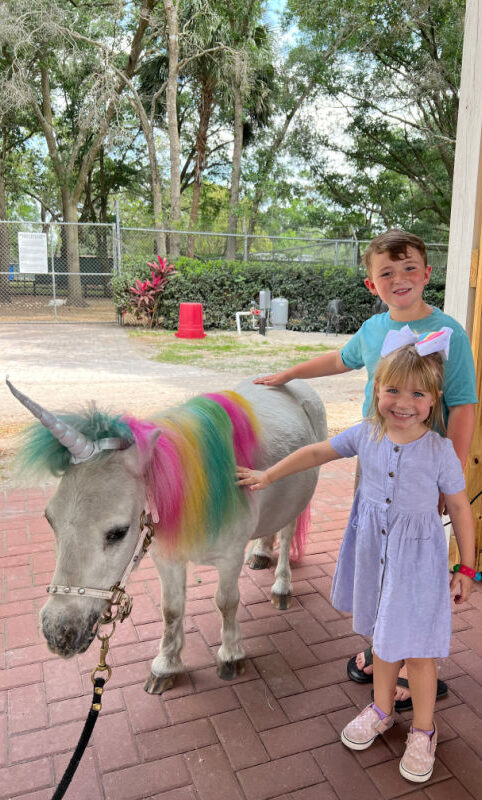 2 kids with a bully unicorn at the reading of Molly's the unicorn's story