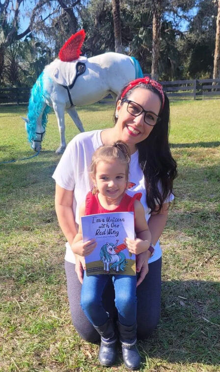 Author carolyn izzo with child at a reading of im a unicorn with one red wing at Cheyne Ranch