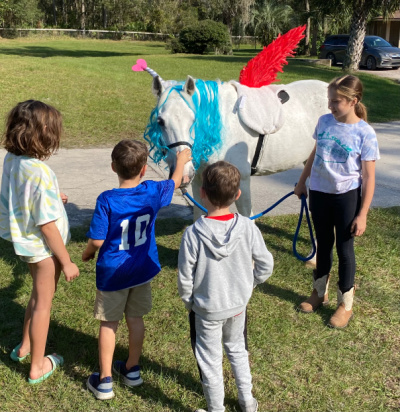 Kids with Molly at Cheyne ranch for reading of im a unicorn with one red wing